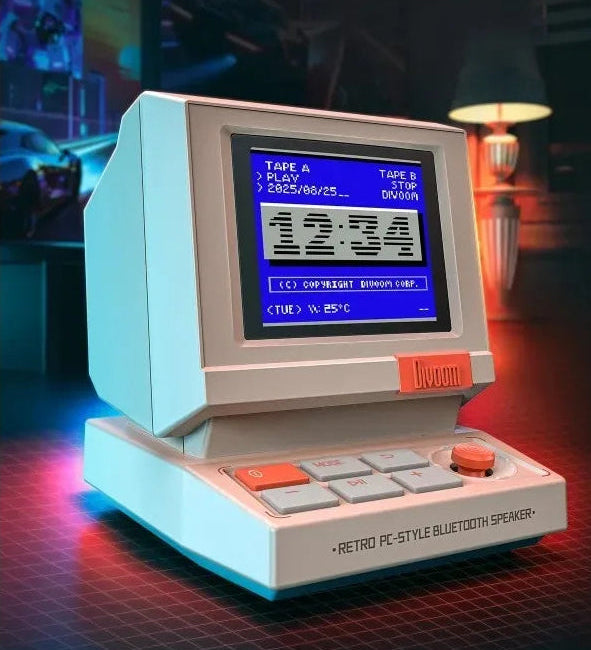 Retro computer speaker with digital display and buttons on a dark background